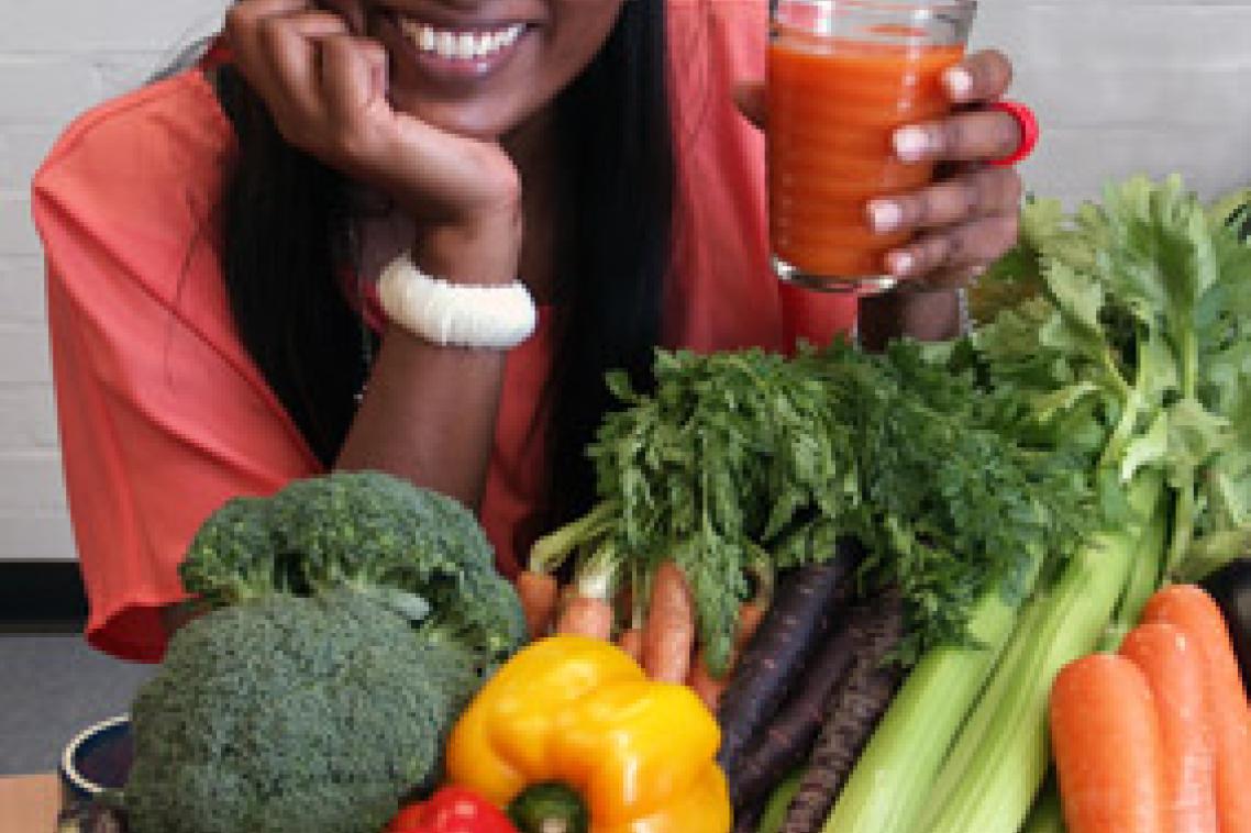 Dr Anneline Padayachee with orange carrot juice and other vegetables included in her research.