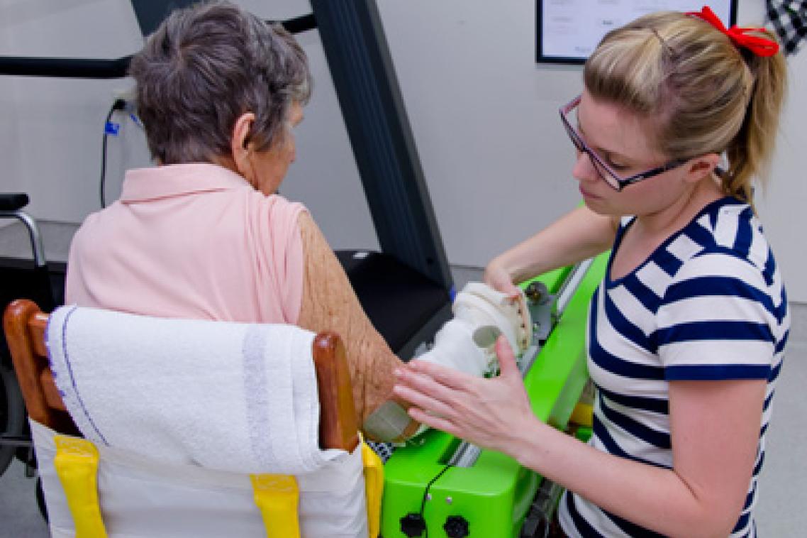 UQ PhD student Kate Hayward from the School of Health and Rehabilitation Sciences helps a stroke patient use SMART Arm, a device developed by UQ and James Cook University to assist stroke survivors with their rehabilitation.