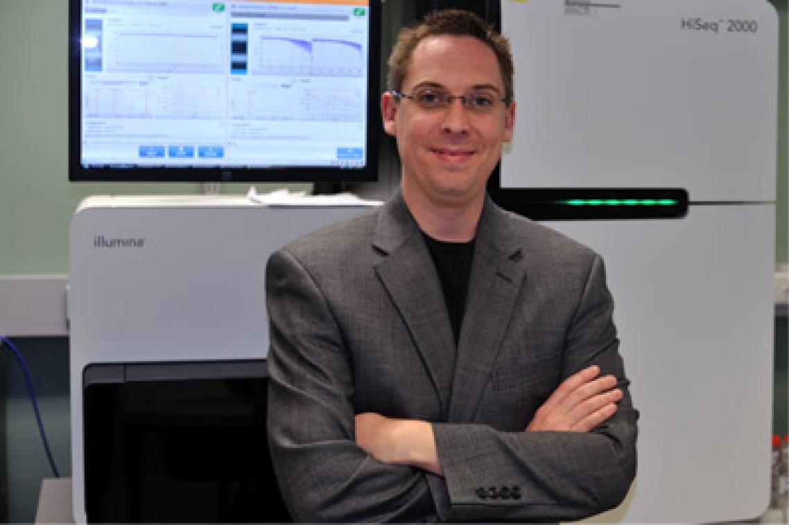 Dr Ryan Taft with an Illumina sequencer, on which the gene sequencing was performed.