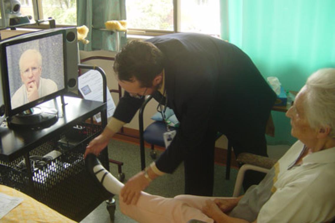 UQ Professor Len Gray consults with a resident in an aged care facility using telehealth.