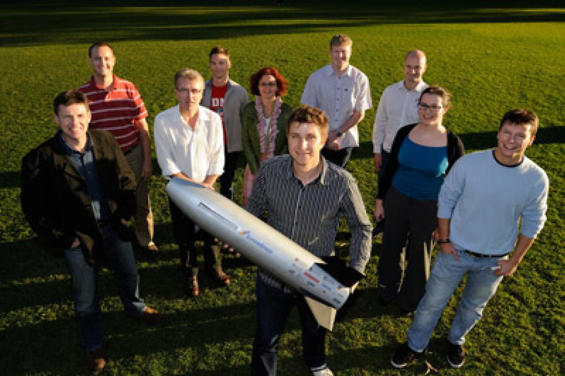 The SCRAMSPACE team with a smaller prototype of the 1.8m long hypersonic scramjet that will be available for public viewing on July 8 at UQ.