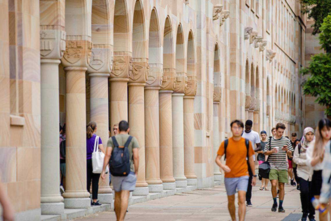 Students walking through the Great Court at UQ St Lucia, which is surrounded by sandstone buildings