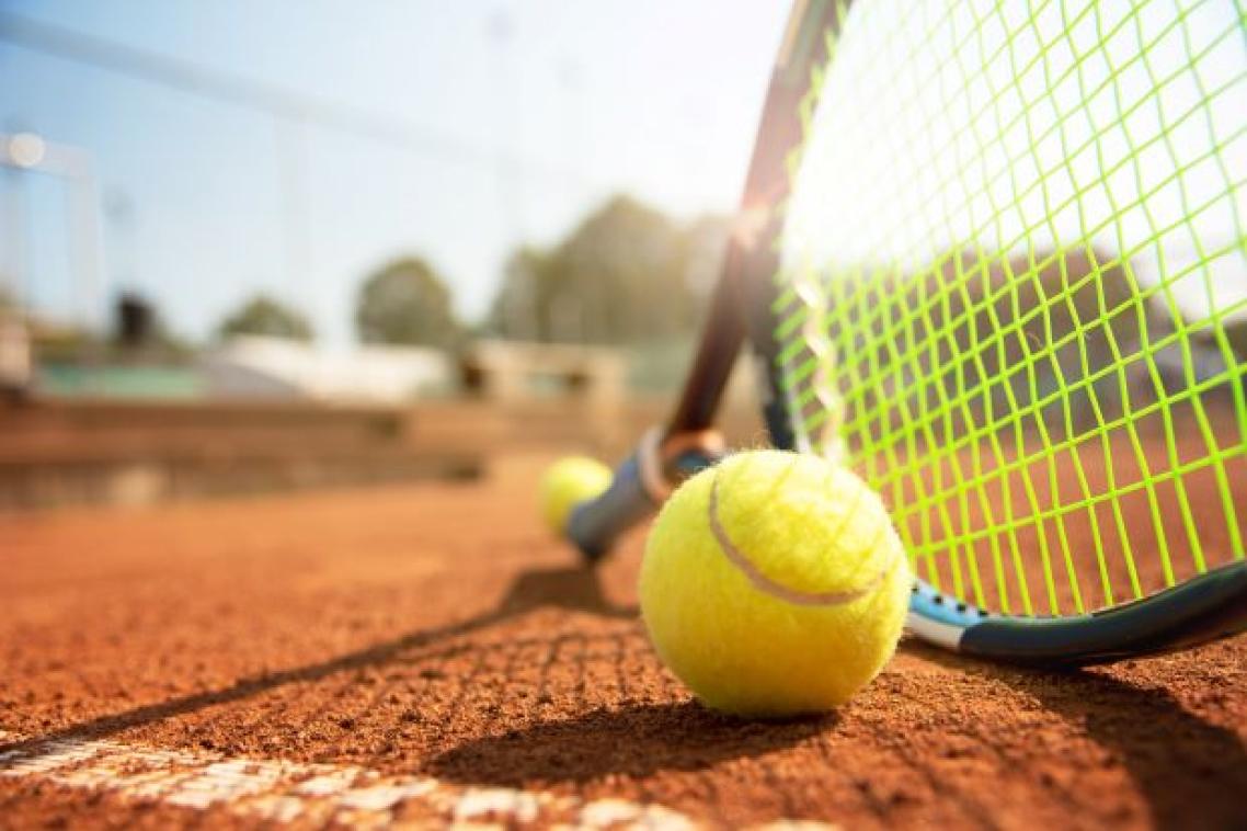 A low angle view of a tennis court, tennis racquet and ball