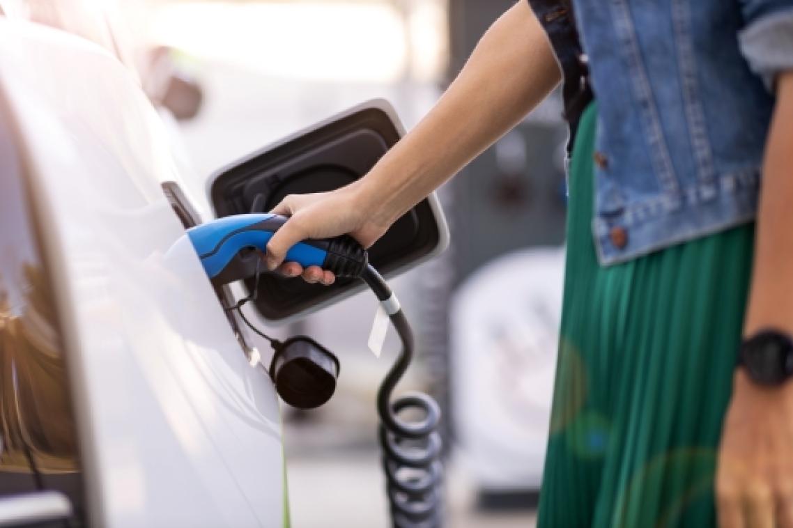 Person charging their electric vehicle.