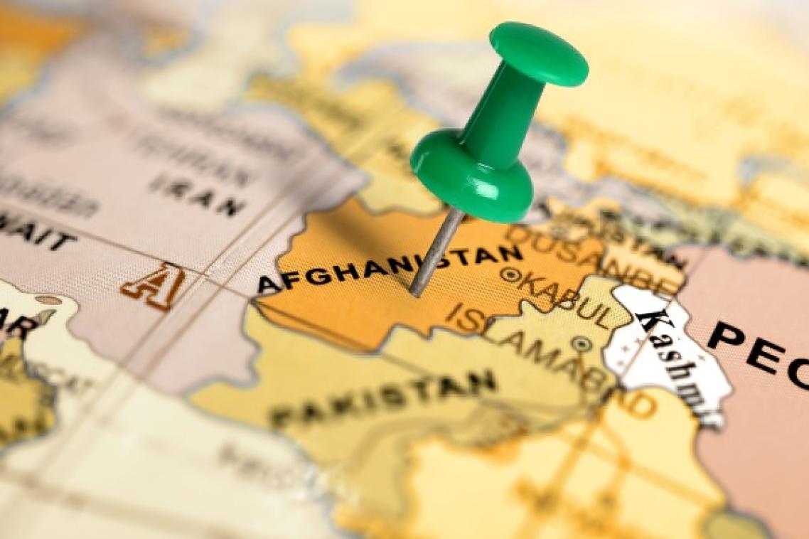 Thumbtack stuck on Afghanistan on world map.