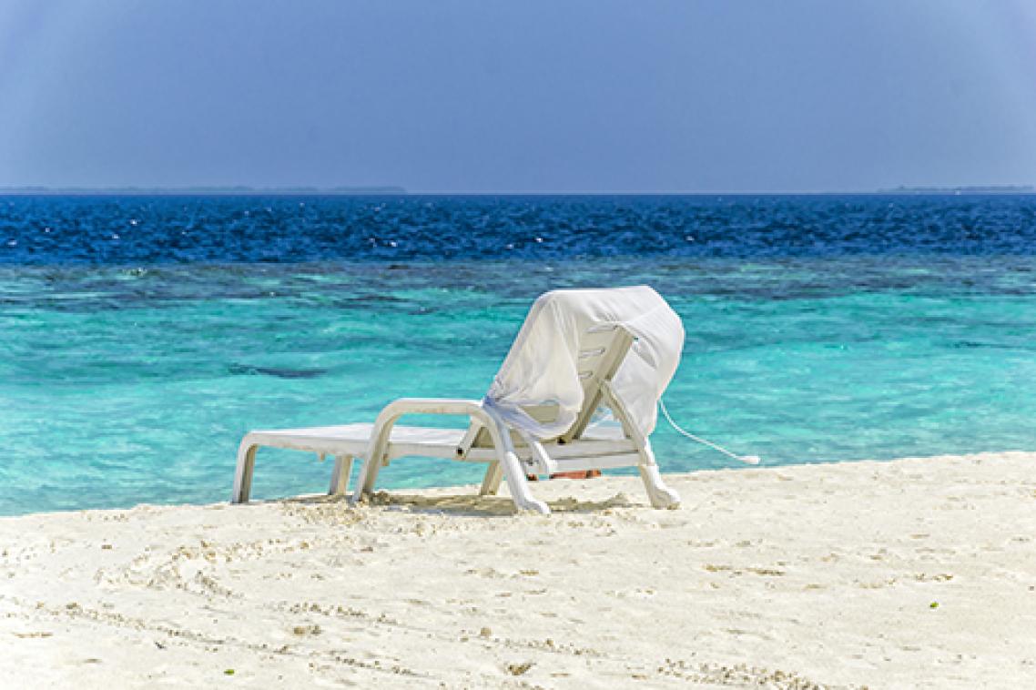 Empty beach chair sitting on a beautiful Queensland beach