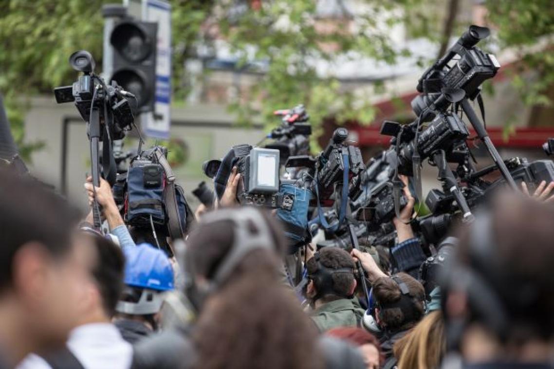 A large group of journalists and camera operators filming event. Image, Adobe.