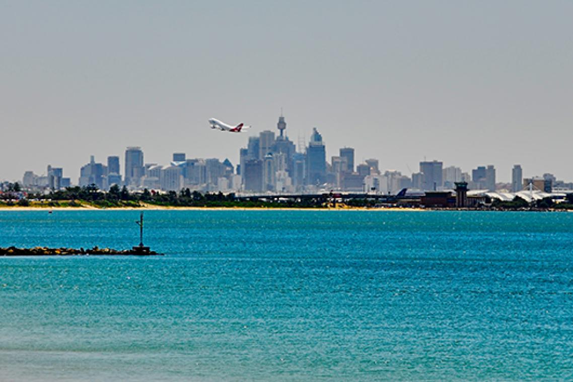 A plane taking-off over water.