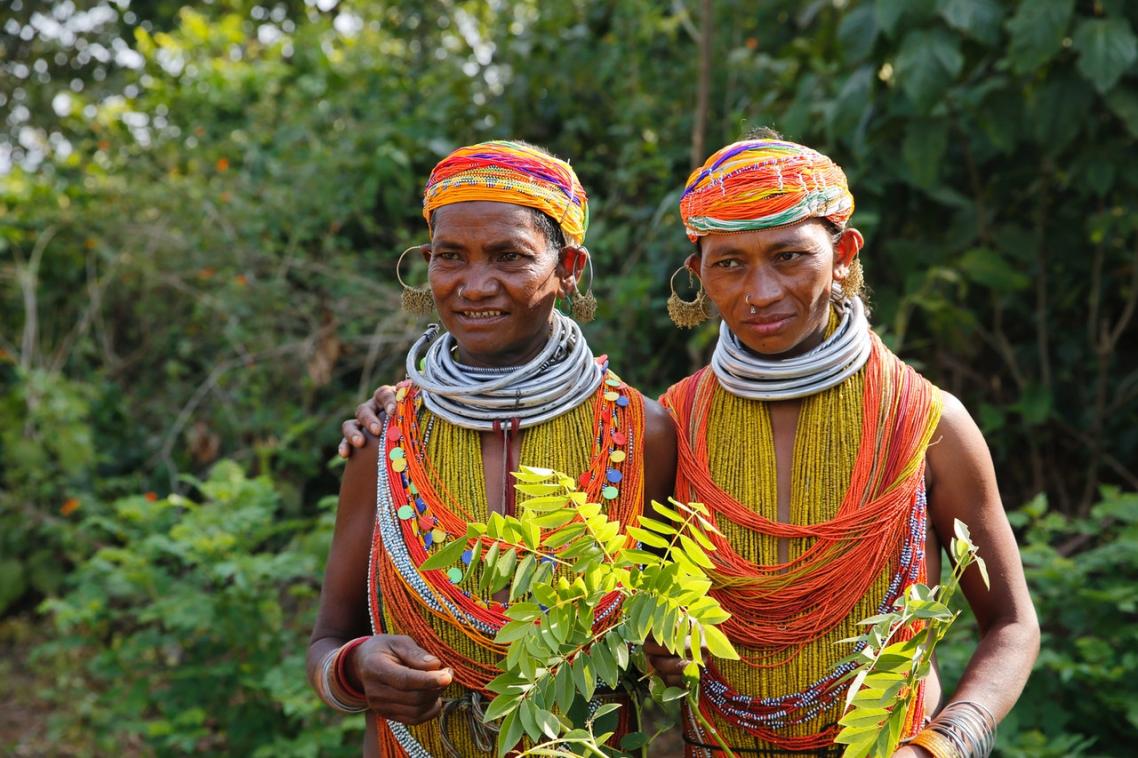 Indigenous villagers in the heavily forested state of Odisha, India, with the forest behind them