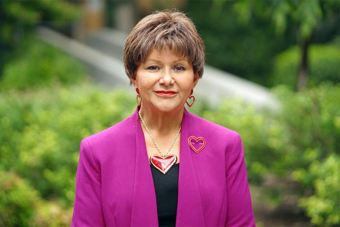 A woman wearing a pink blazer