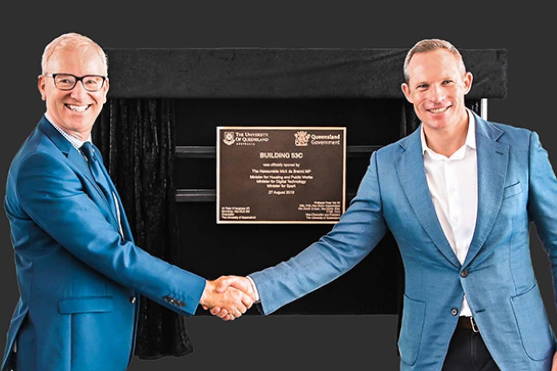 Minister for Sport Mick de Brenni and UQ Pro-Vice-Chancellor Professor Tim Dunne shake hands in front of the building plaque