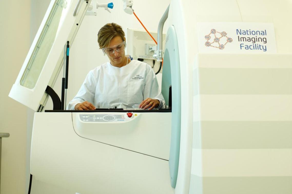 NIF Facility Fellow Dr Karine Mardon with the Positron Emission Tomography/Computed Tomography (PET/CT) hosted at the Centre for Advanced Imaging. 