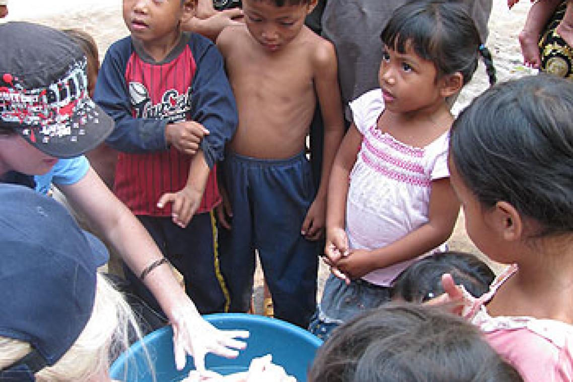 UQ students complete a hand washing demonstration with children in Siem Reap, Cambodia. Image: Peta Crompton