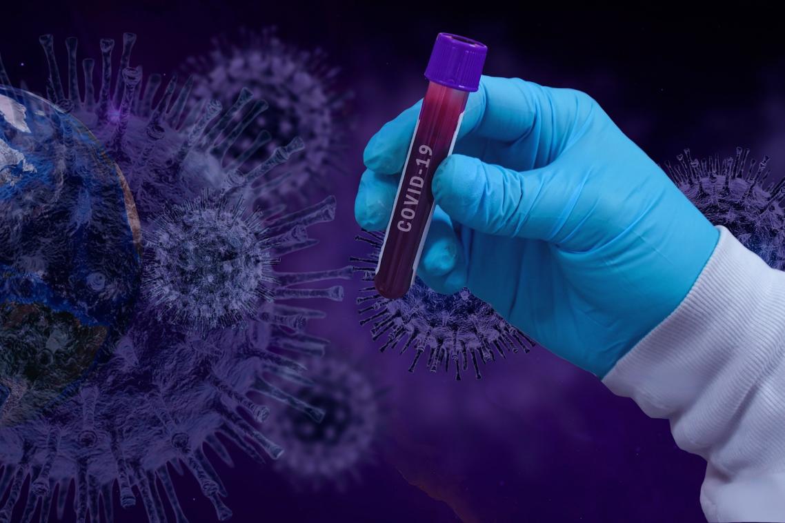 Pixabay: gloved hand holding test tube with cells juxtaposed behind