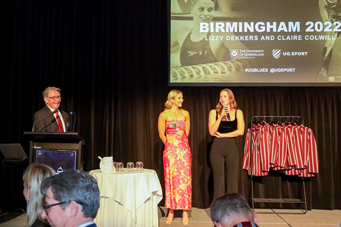 Two women standing on a stage at an awards event