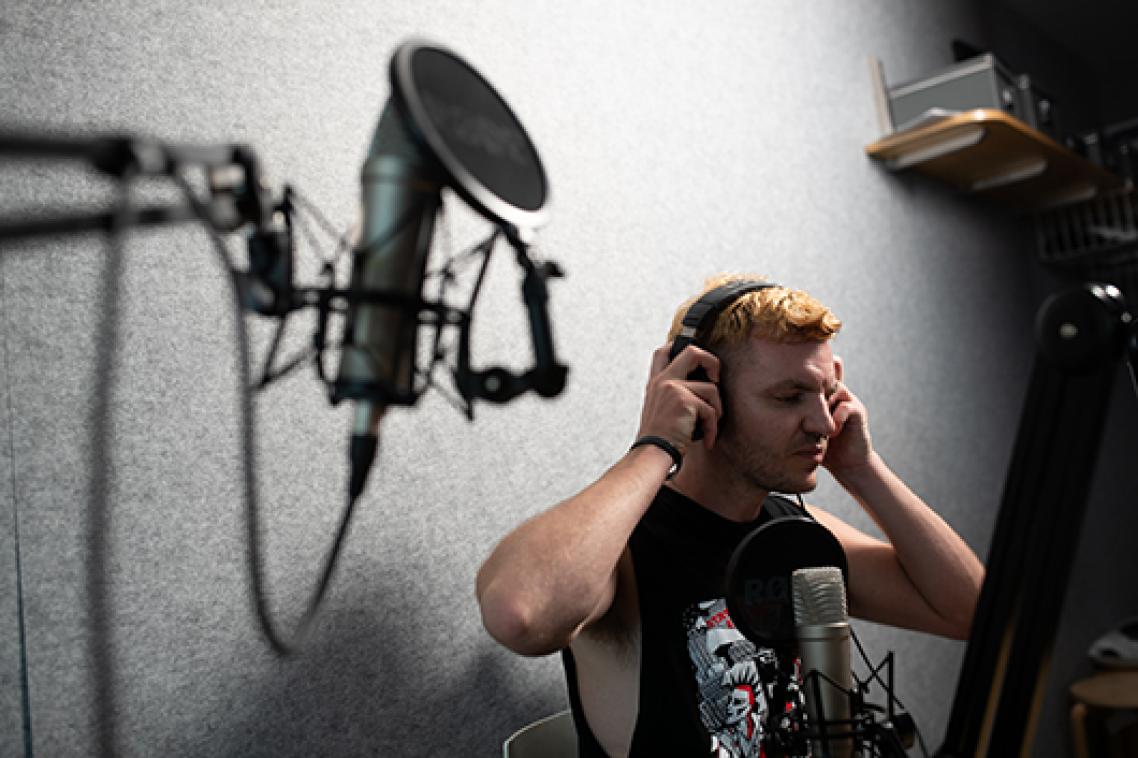 A man putting on a pair of headphones
