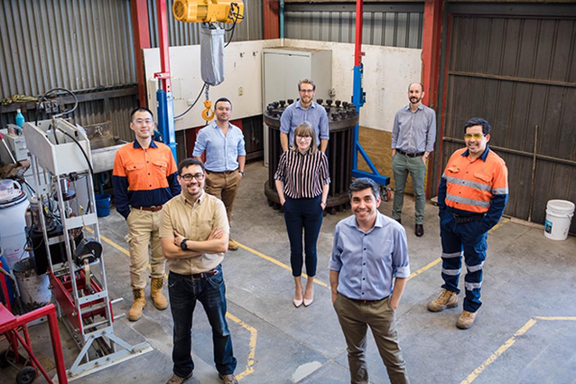 UQ blasting and fragmentation technology team standing socially distanced in a lab