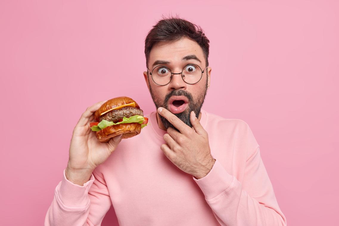 A man eating a fly burger