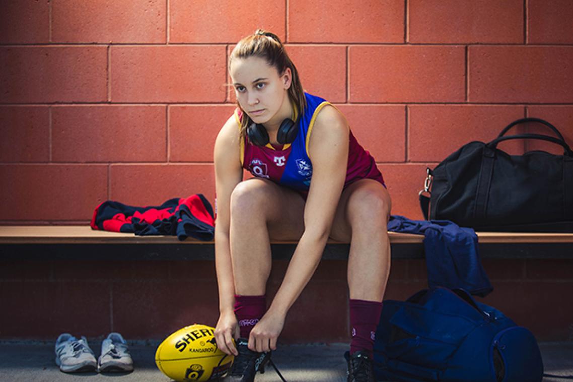 Grider laces up her boots in the change rooms.