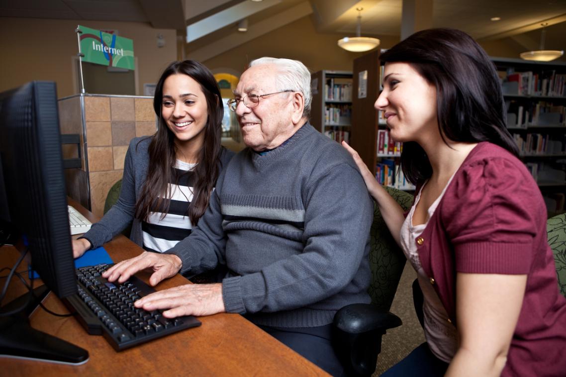 An older man with two family members undergoes a counselling session.