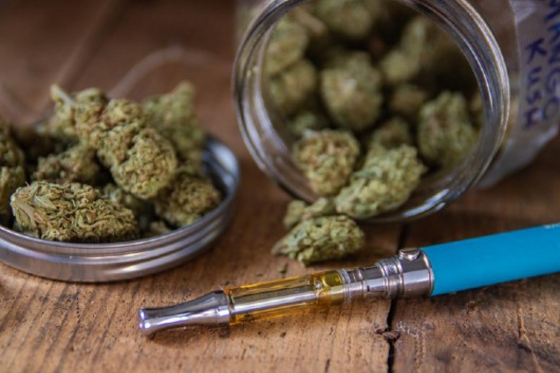Buds of cannabis with vaping utensil.