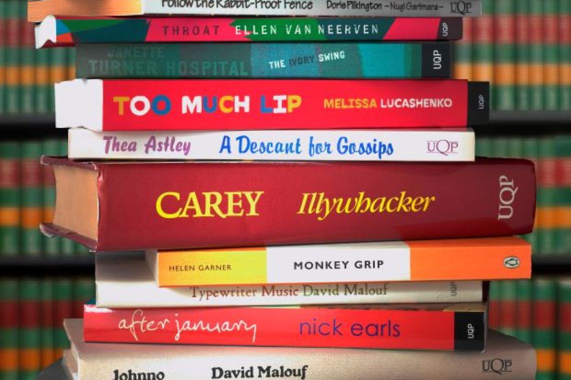 A stack of around a dozen Australian novels, with their spines showing.