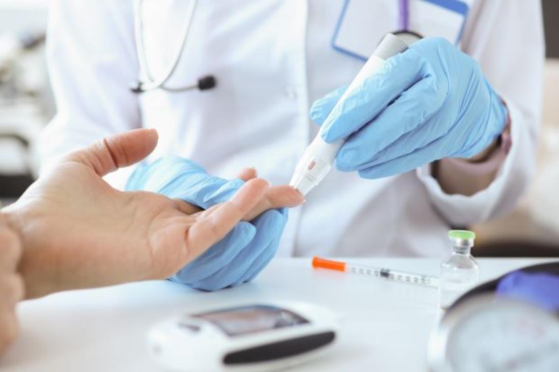 Doctor with gloves on taking blood sugar level of patient. Adobe
