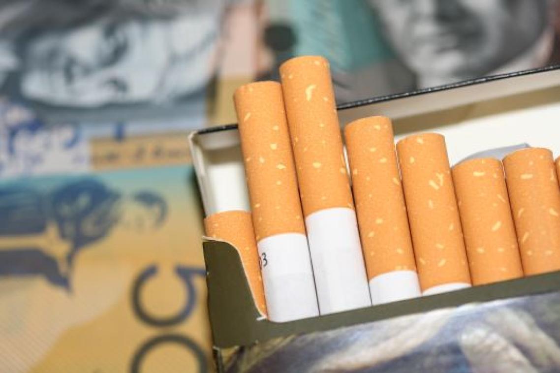Open packet of cigarettes with $A50 note in the background.