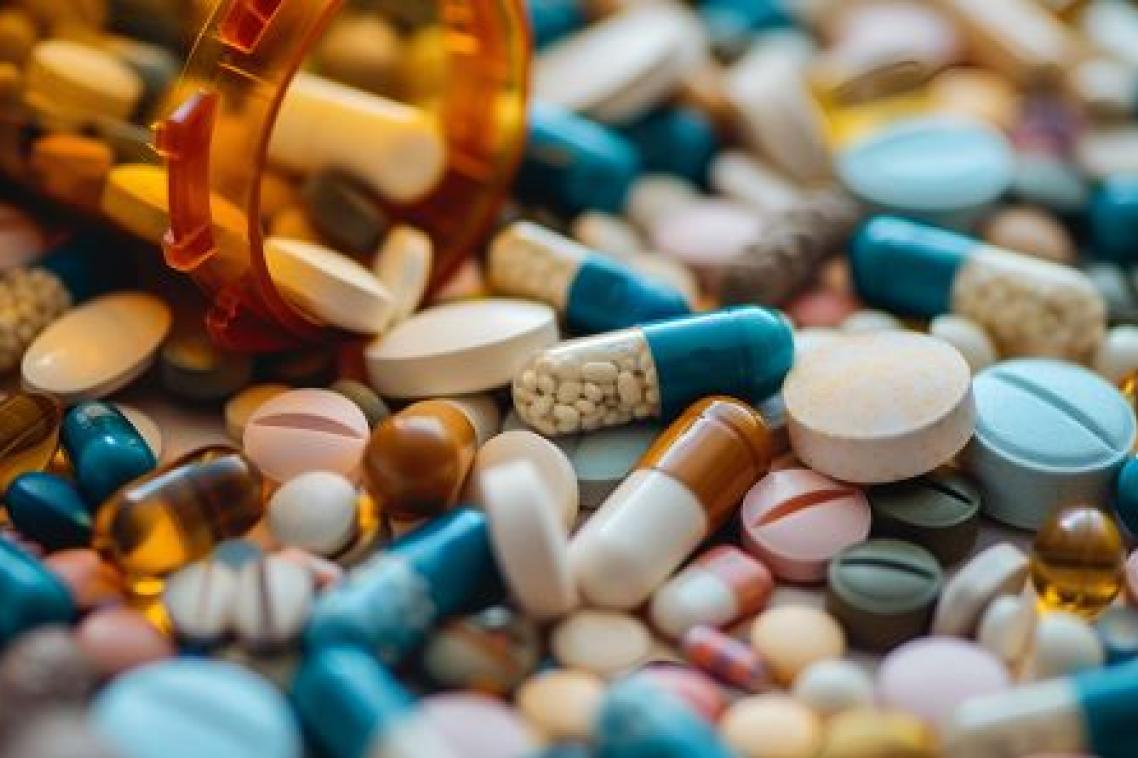 Coloured pills falling out of a container