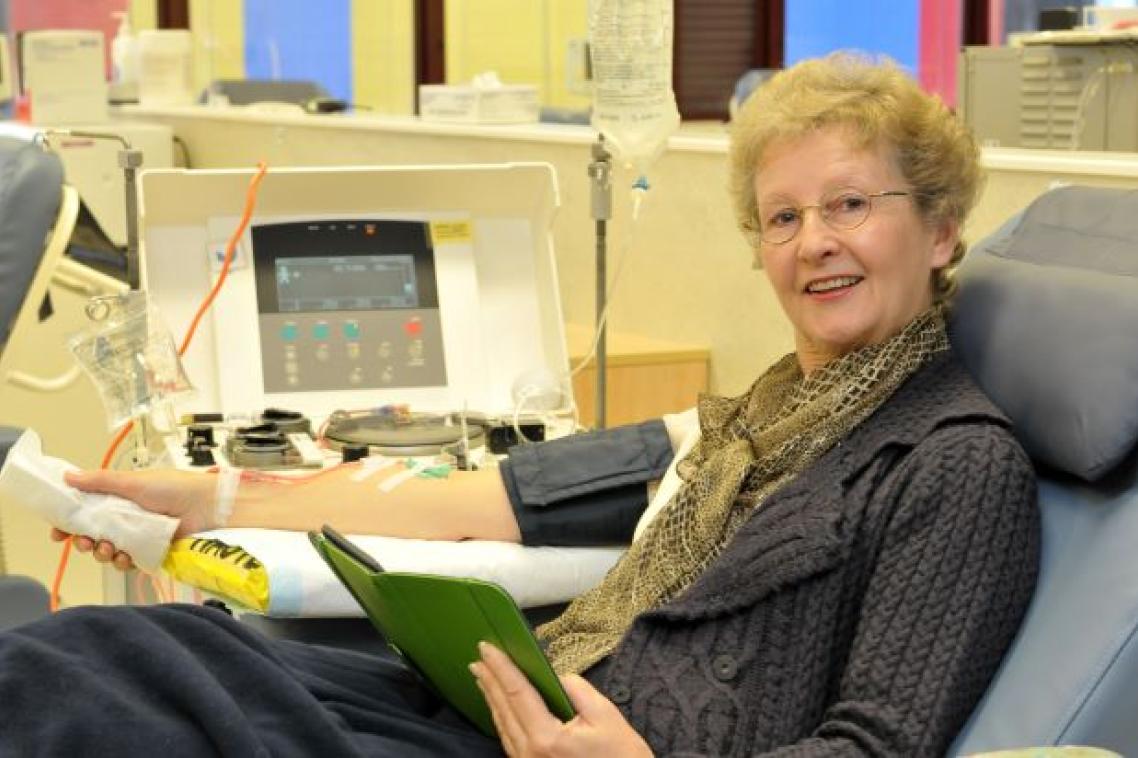 A older woman sitting in a hospital chair