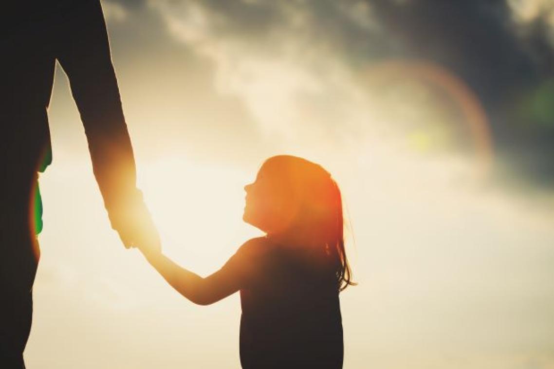 A shadow of a little girl holding a parent's hand