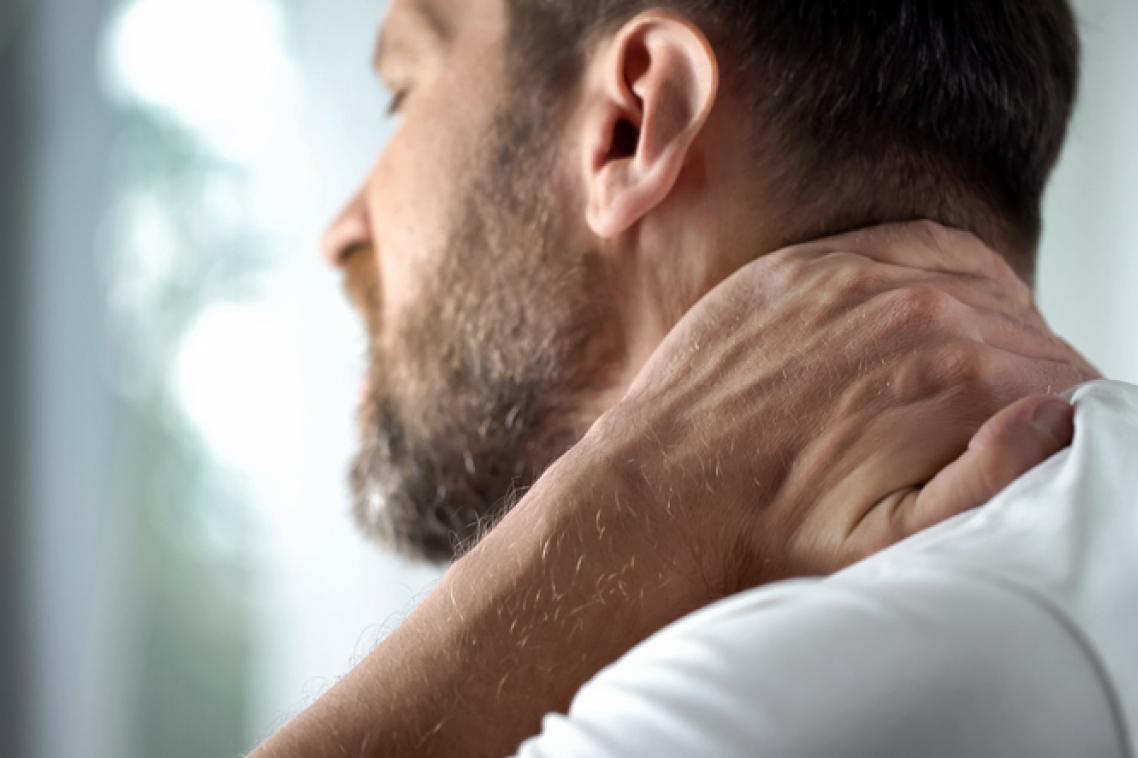 Man holding his neck in pain