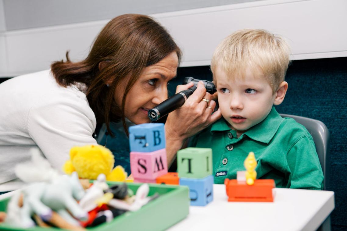 A clinician works with a child at the UQ Audiology clinic.