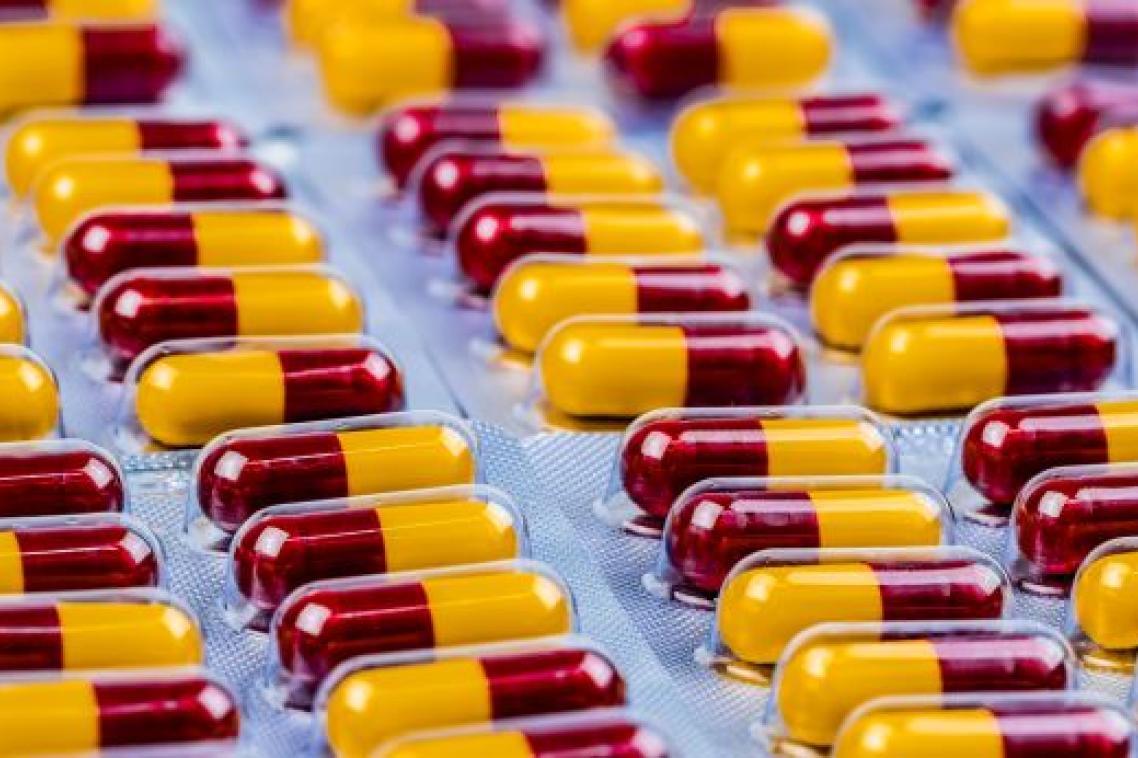 Rows of maroon and yellow capsule medication in blister packs