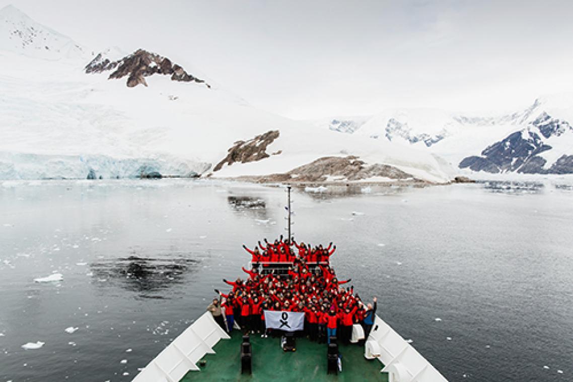 Scientists-on-bow-of-ship-in-Antarctica