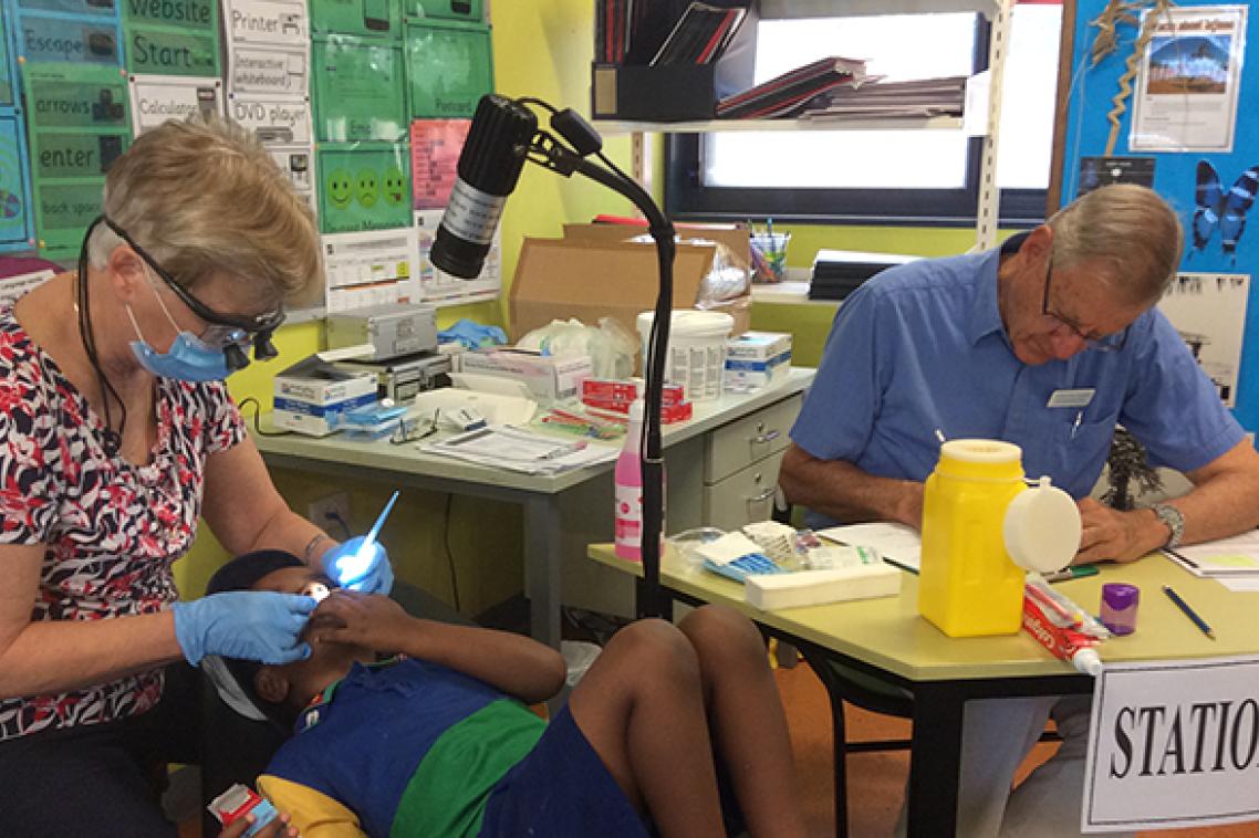 A young boy receives preventative oral dental treatments