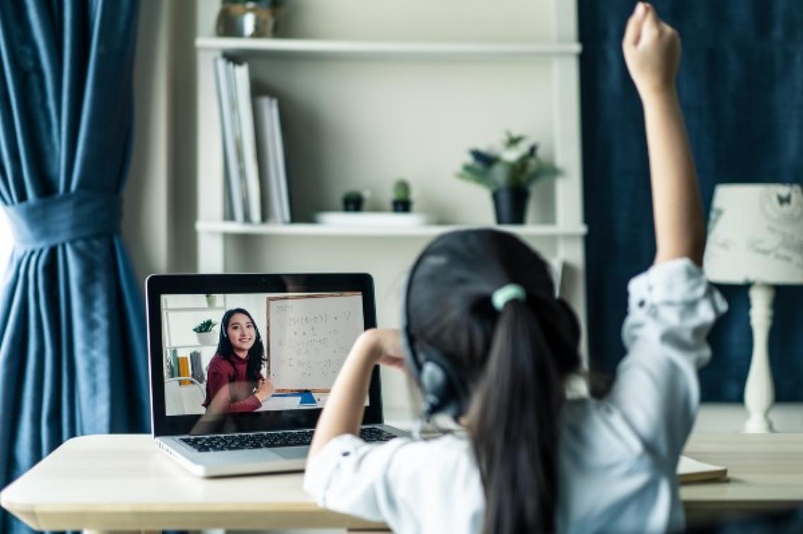 Young girl sitting at desk while being homeschooled.