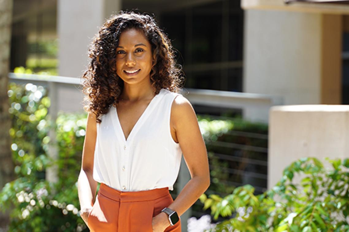 A woman in a white shirt smiling