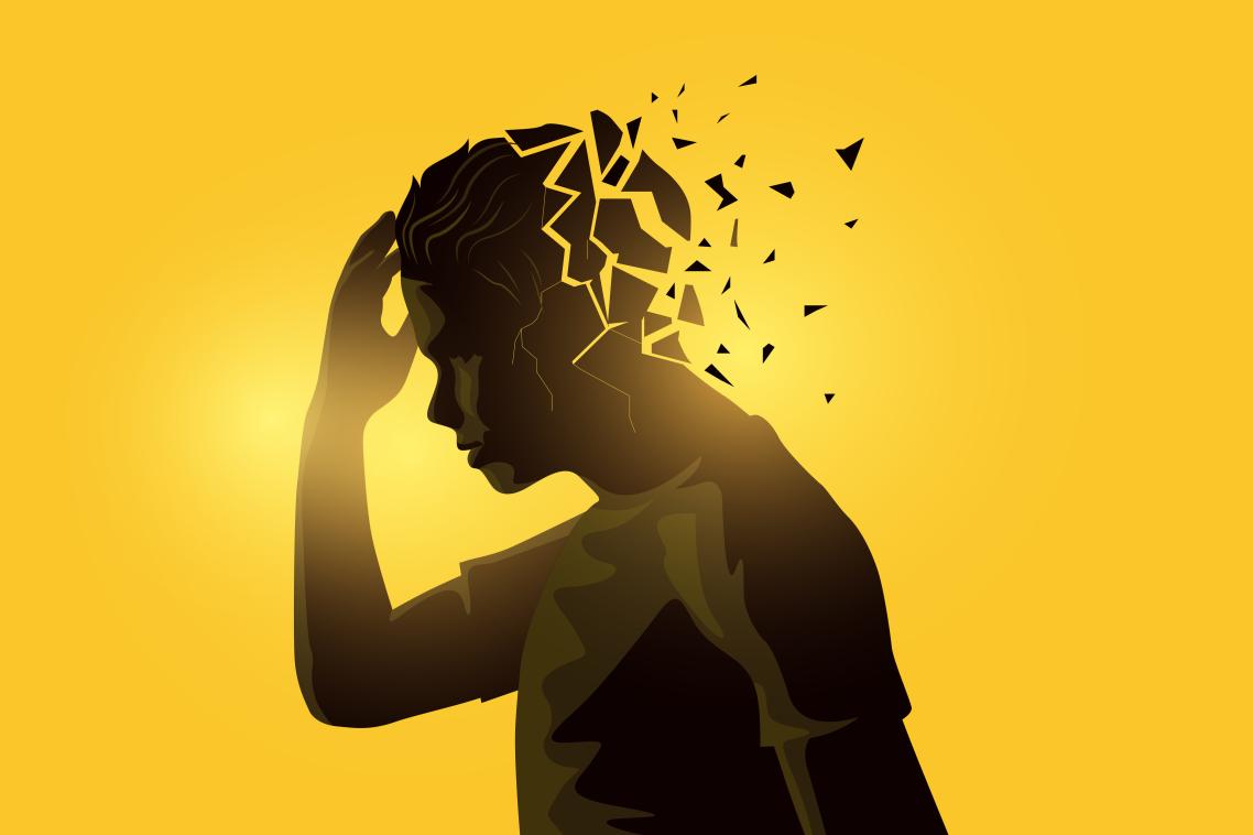 Silhouette of man holding head