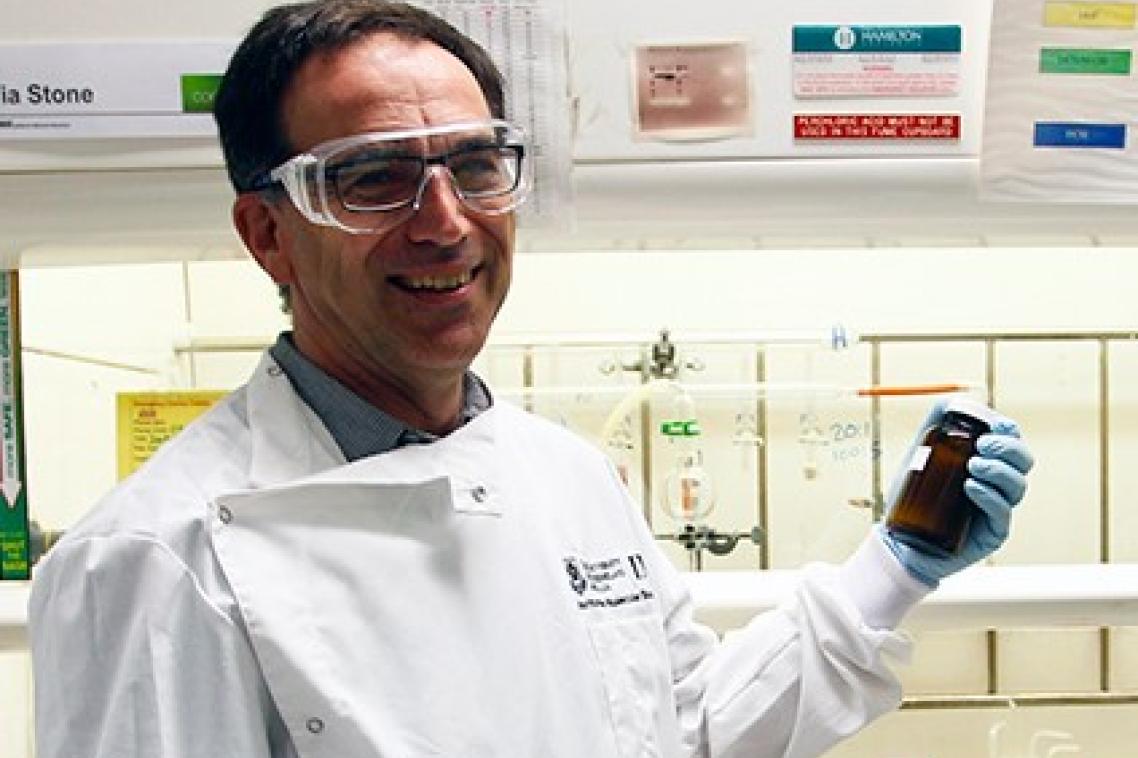 Associate Professor Mark Blaskovich holds a sample in the lab.
