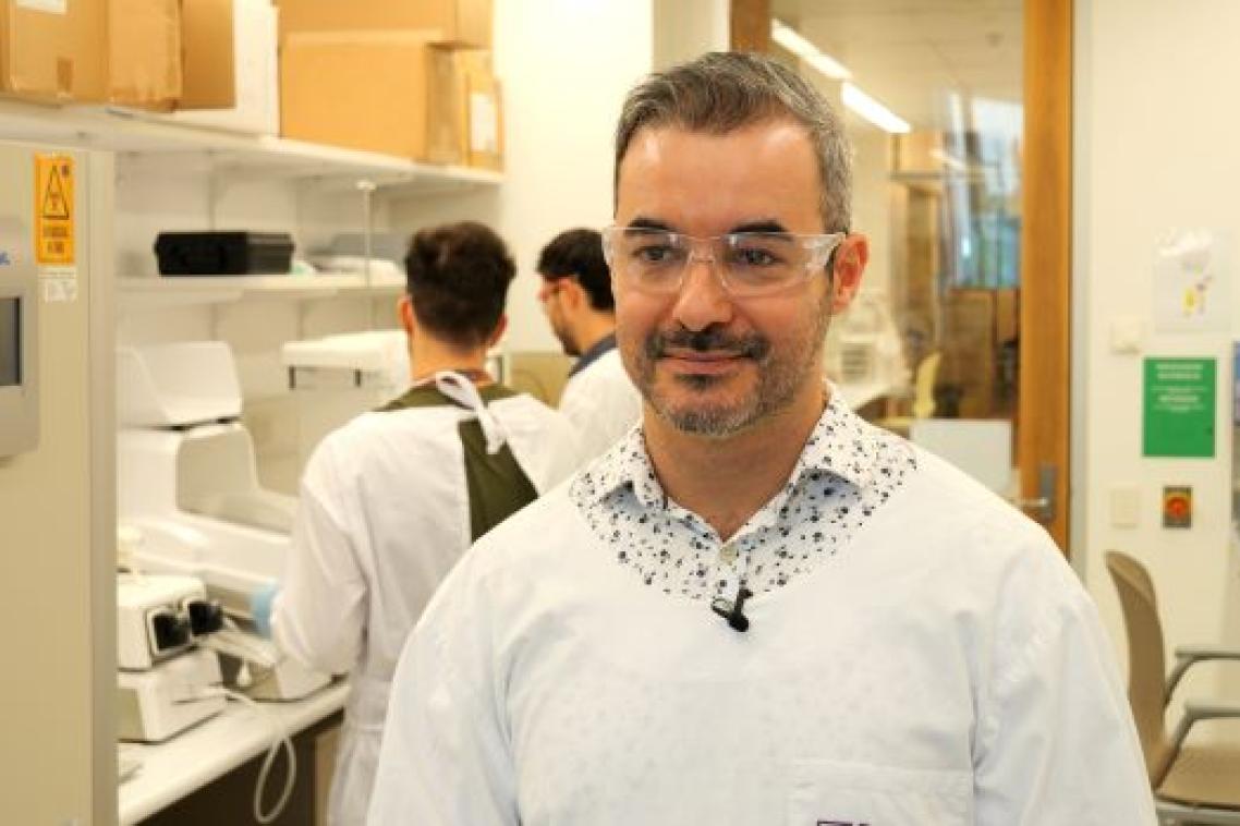 A man in a lab coat and glasses
