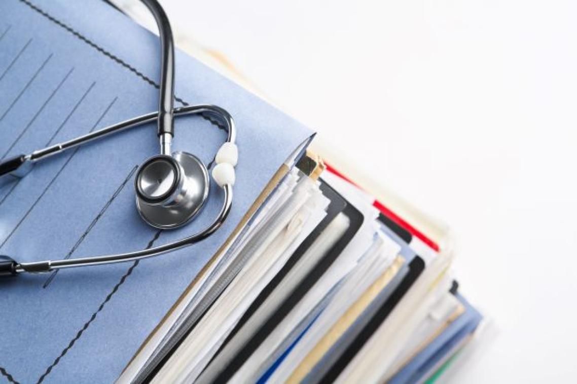 a stethoscope sits on top of a pile of files