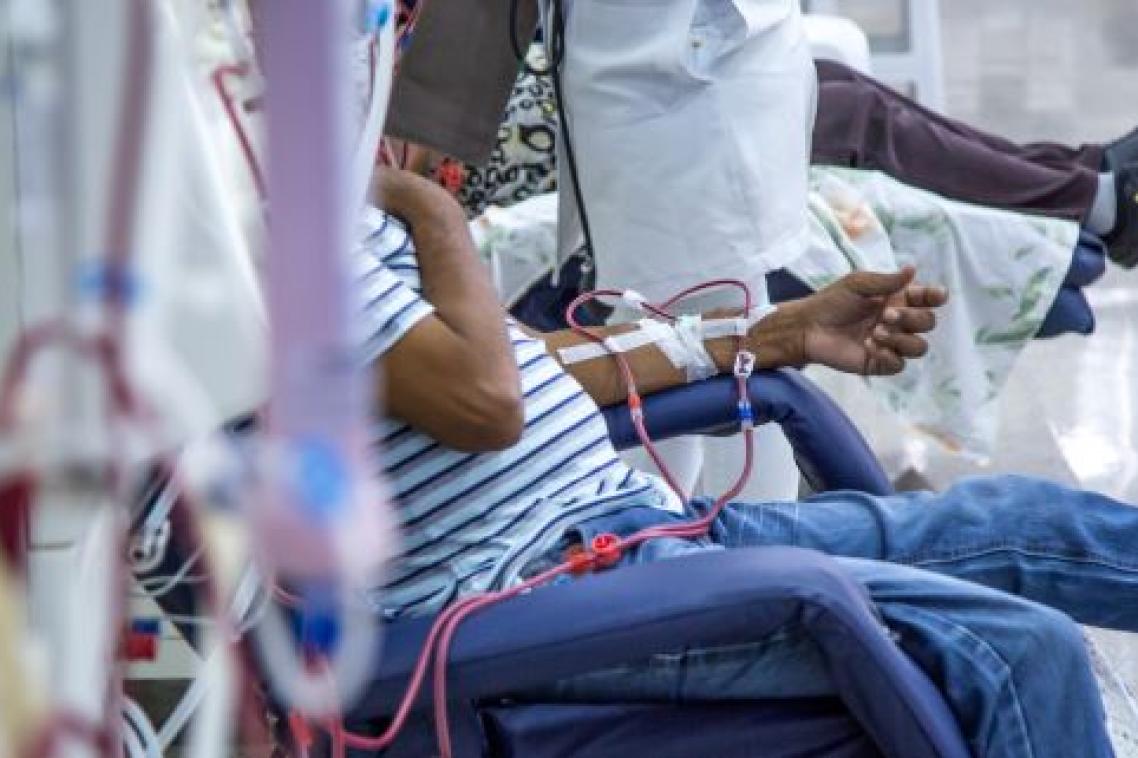 Unidentified patient sitting in chair while undergoing kidney dialysis. Image, Adobe