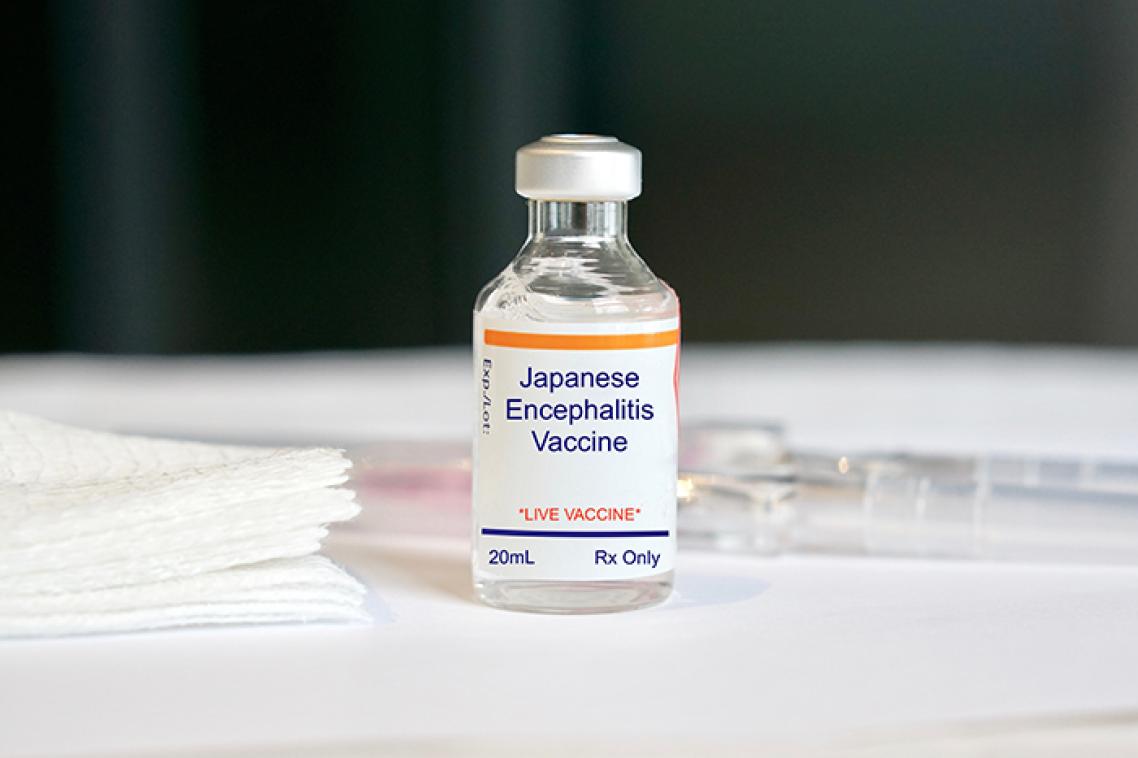 Vital of Japanese encephilities vaccine on a white table with label clearly visible