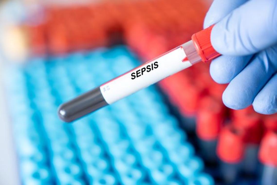 A gloved hand holds a pipette containing blood, with a label that reads Sepsis.