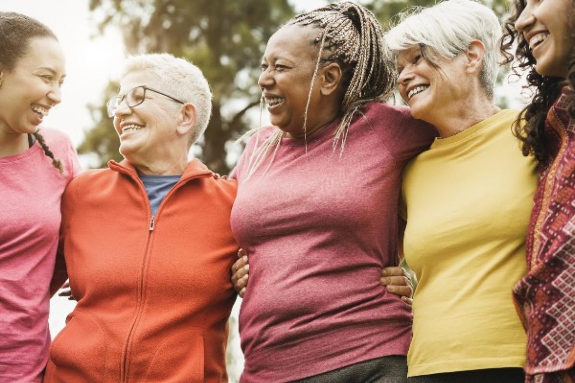 Group of women with arms around each other.