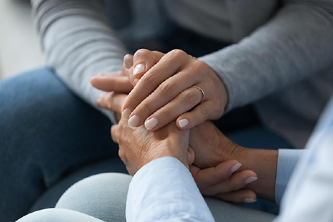 A woman holding hand of another woman