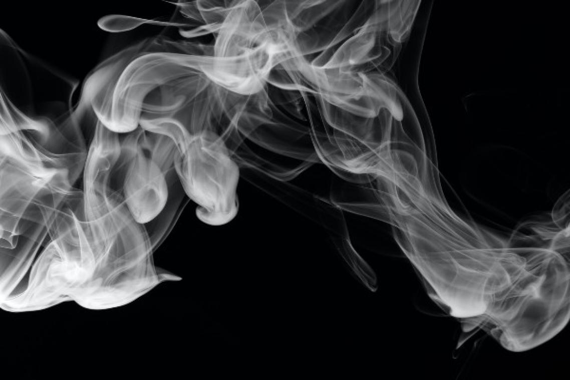 Cigarette smoke on black background.