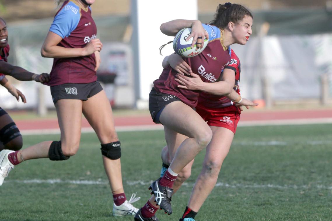 UQ-player-Marioulla-Belessis-is-tackled-as-she-runs-the-ball-forward