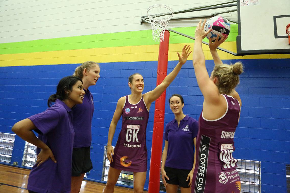 Bluejays players with Queensland Firebirds Laura Clemesha (L) and Gabi Simpson (R)